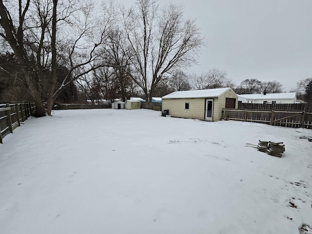 yard covered in snow featuring an outdoor structure