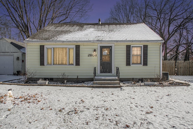 bungalow-style house with an outbuilding, central AC, and a garage