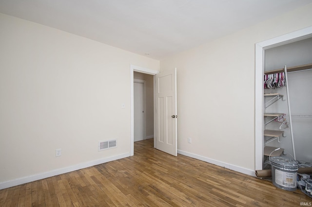 unfurnished bedroom featuring a closet and wood-type flooring