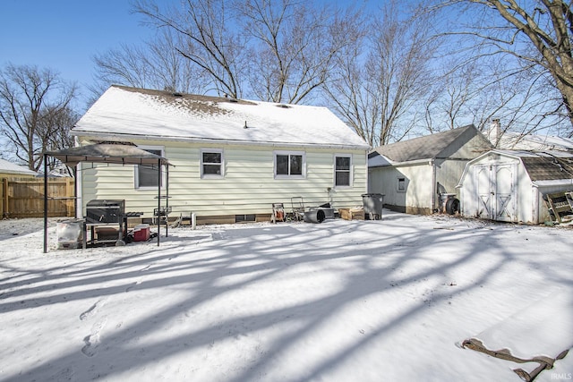 snow covered house with a gazebo and a shed