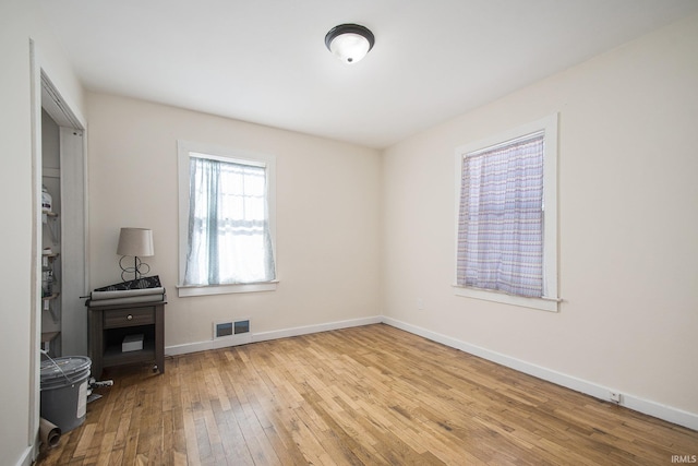 empty room with light hardwood / wood-style flooring