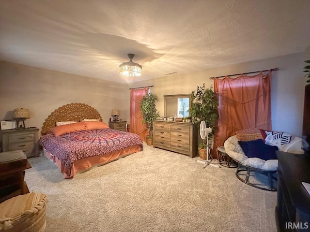 carpeted bedroom with a textured ceiling