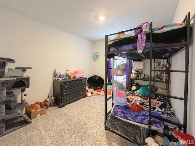 bedroom with a textured ceiling and carpet flooring