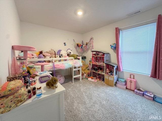 bedroom with carpet floors and a textured ceiling