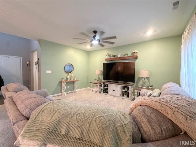 carpeted living room with ceiling fan