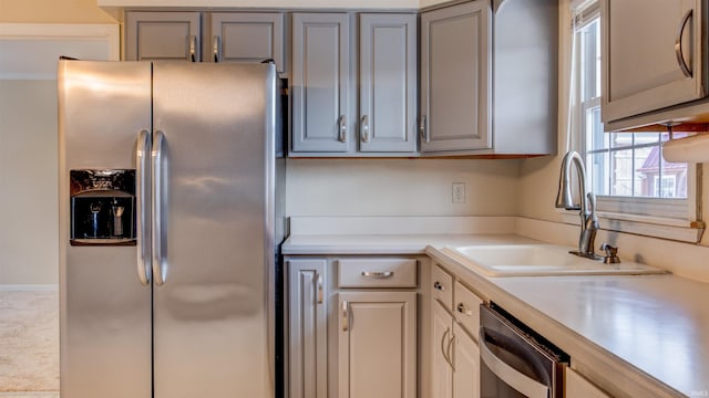 kitchen with sink, appliances with stainless steel finishes, and gray cabinetry