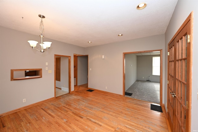 interior space featuring light hardwood / wood-style flooring and a chandelier