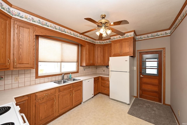 kitchen with white appliances, crown molding, sink, backsplash, and ceiling fan