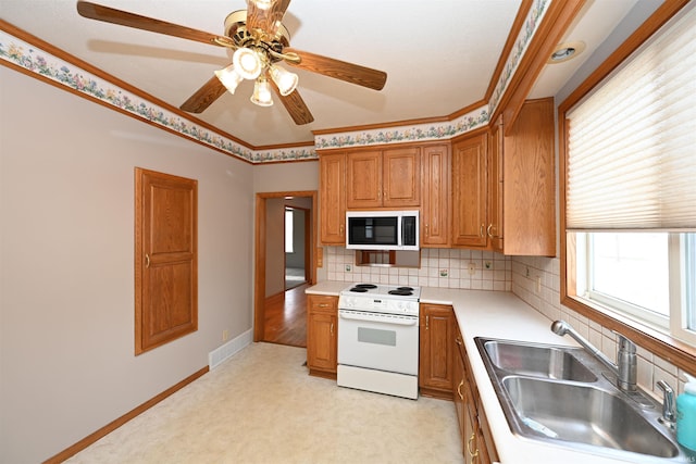 kitchen featuring sink, light colored carpet, tasteful backsplash, and electric stove