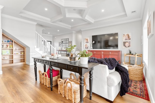 living room with built in features, coffered ceiling, beamed ceiling, and ornamental molding