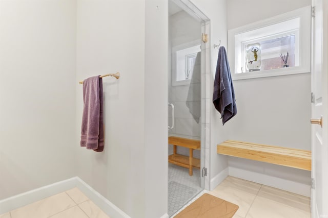 bathroom with walk in shower and tile patterned flooring