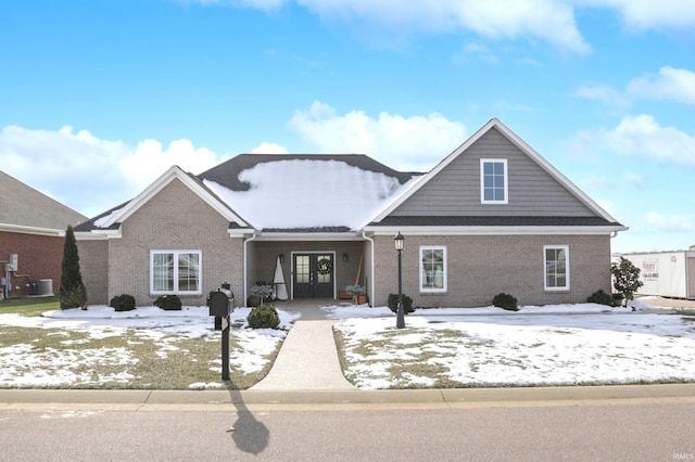 view of front facade featuring french doors and central AC