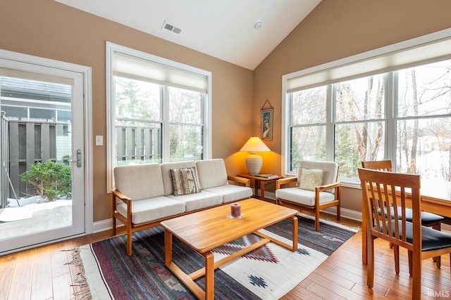 sunroom / solarium featuring vaulted ceiling