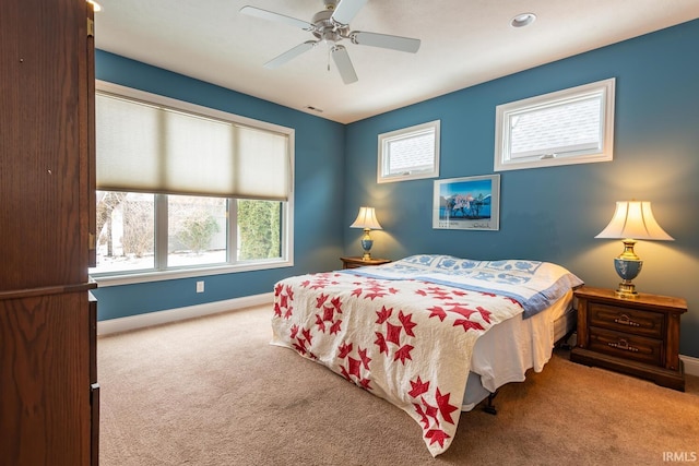 bedroom with ceiling fan and light colored carpet