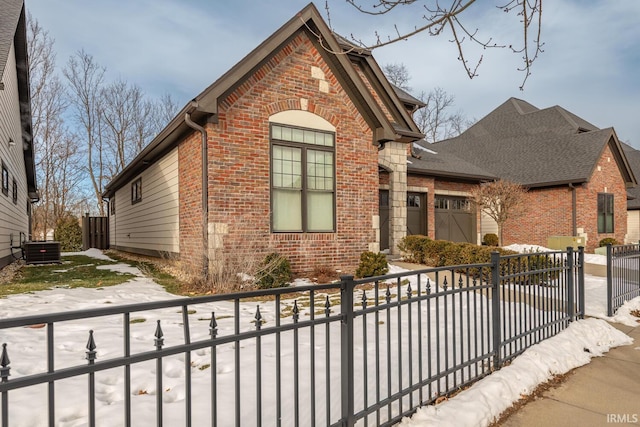 view of front property with a garage and central AC unit