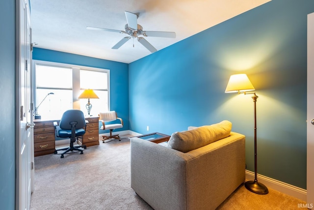 carpeted office space featuring ceiling fan