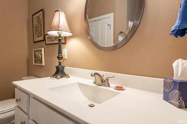 bathroom with toilet and vanity