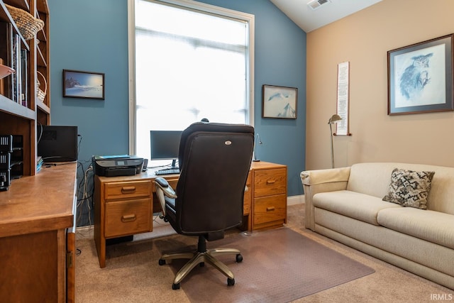 office area with light colored carpet and vaulted ceiling