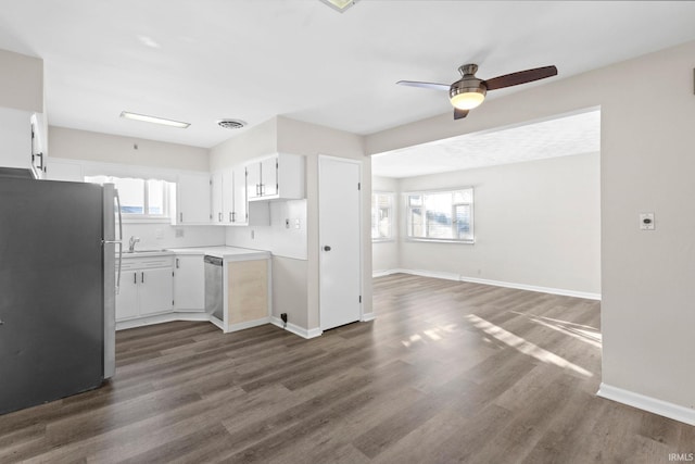 kitchen featuring a wealth of natural light, white cabinets, dark hardwood / wood-style floors, and stainless steel appliances