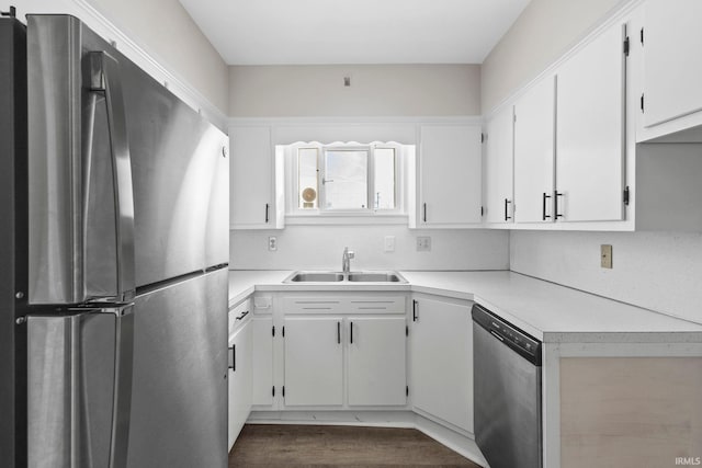 kitchen with sink, white cabinets, and appliances with stainless steel finishes