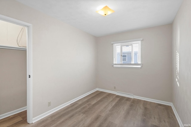 empty room with light hardwood / wood-style flooring