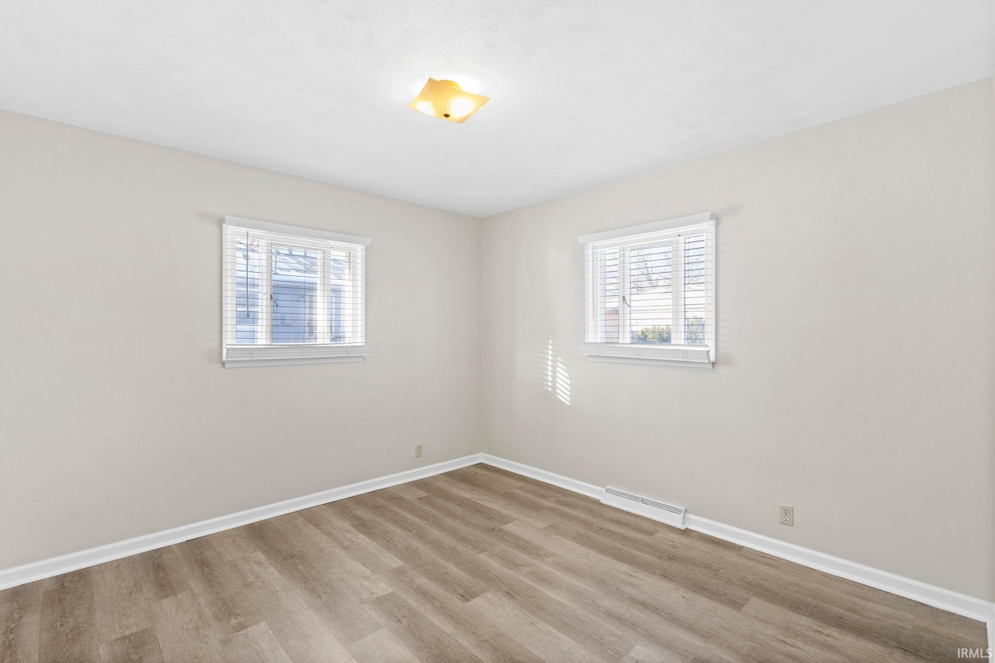 spare room featuring light hardwood / wood-style flooring