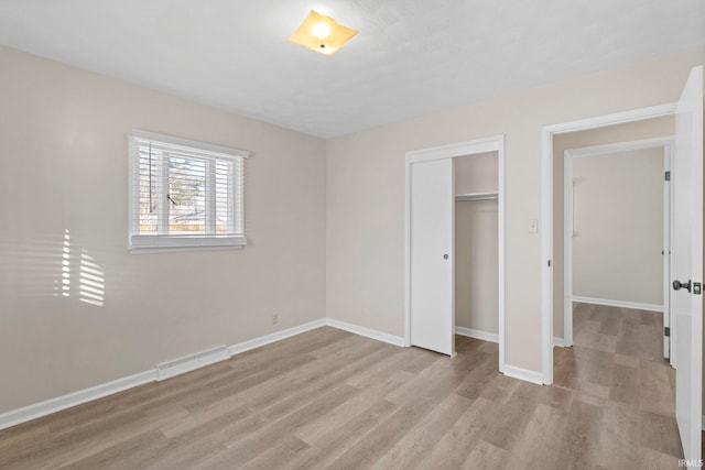 unfurnished bedroom featuring a closet and light wood-type flooring