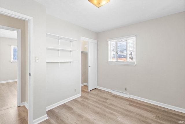 unfurnished bedroom featuring a closet and light hardwood / wood-style flooring