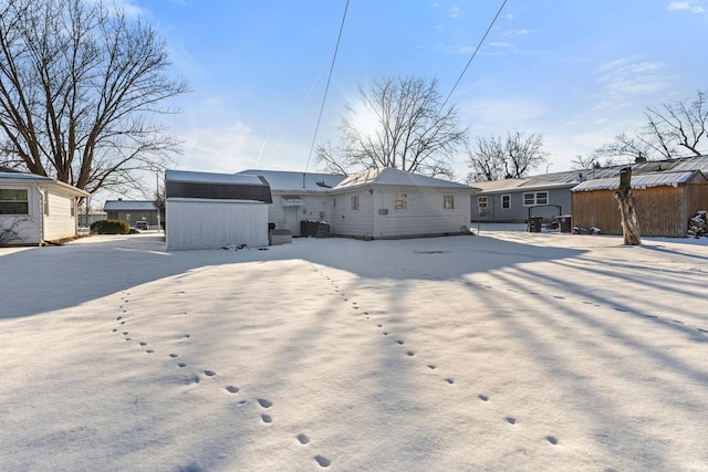 back of property featuring a storage unit