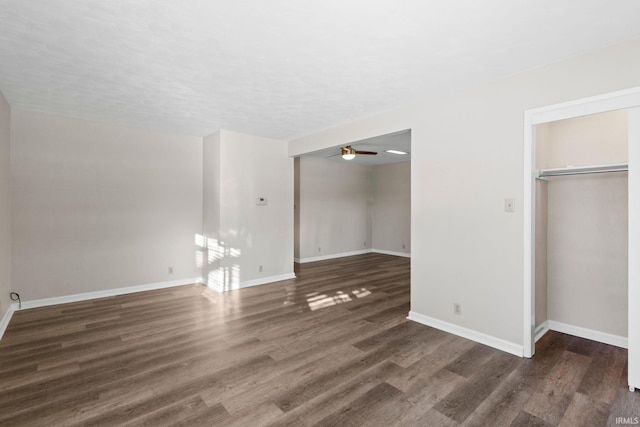 unfurnished bedroom with a closet and dark wood-type flooring