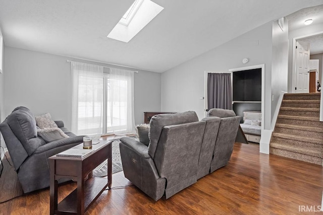 living room featuring lofted ceiling with skylight and dark hardwood / wood-style flooring