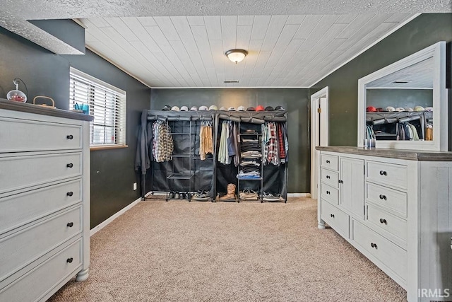 walk in closet with light carpet