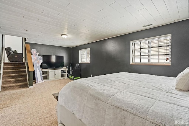 carpeted bedroom with wooden ceiling