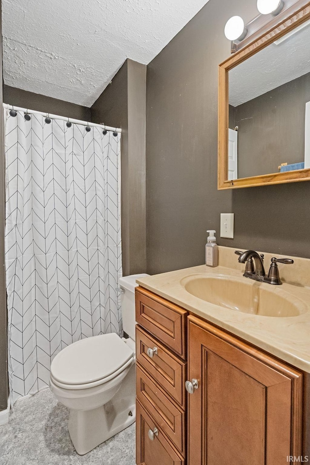 bathroom featuring vanity, curtained shower, a textured ceiling, and toilet