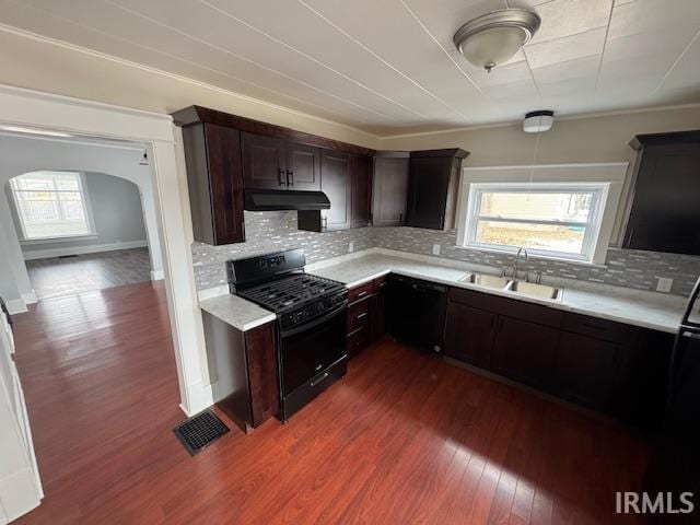 kitchen featuring black appliances, dark brown cabinets, sink, dark hardwood / wood-style flooring, and a healthy amount of sunlight