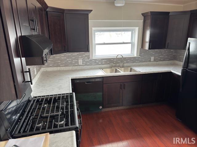 kitchen featuring black appliances, dark hardwood / wood-style flooring, decorative backsplash, sink, and dark brown cabinets