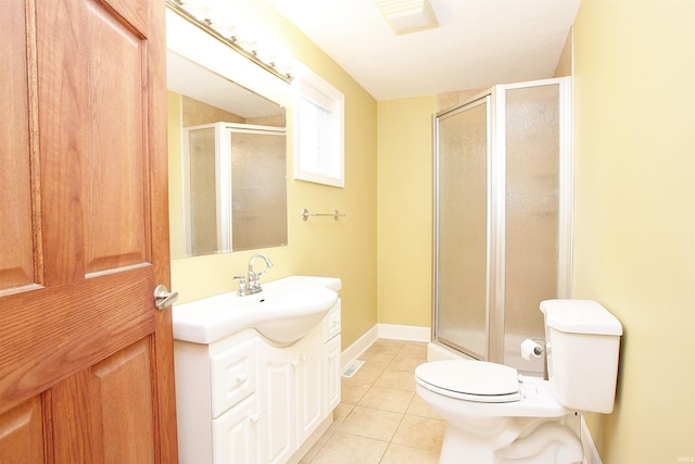 bathroom with vanity, toilet, a shower with door, and tile patterned flooring