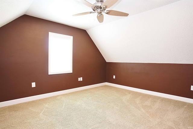 bonus room featuring ceiling fan, lofted ceiling, and carpet flooring