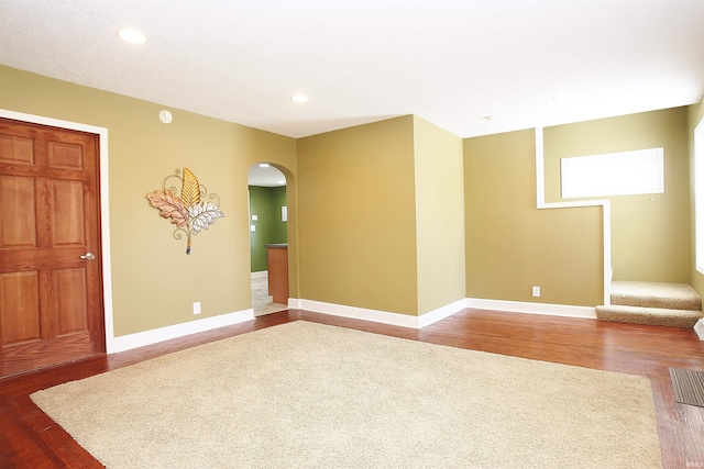 spare room featuring wood-type flooring