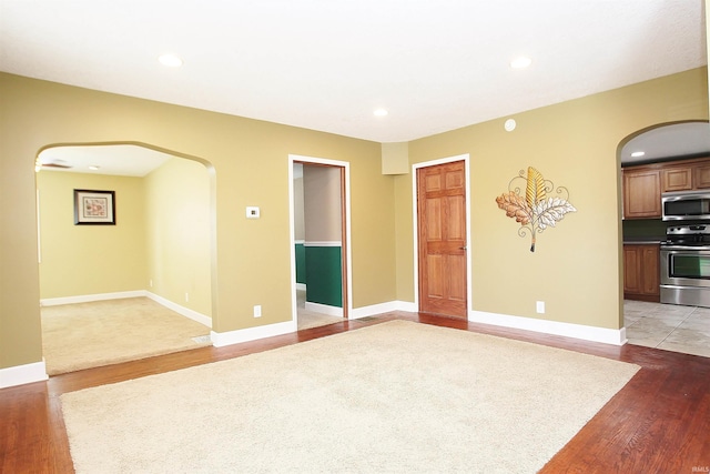 spare room with hardwood / wood-style flooring