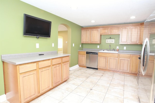 kitchen featuring light tile patterned floors, sink, light brown cabinets, and appliances with stainless steel finishes