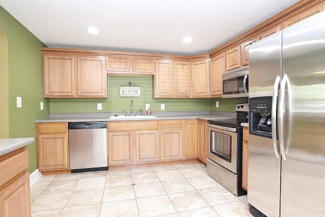 kitchen featuring light tile patterned floors, sink, light brown cabinets, and appliances with stainless steel finishes