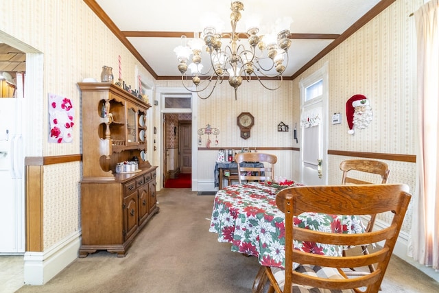 carpeted dining space featuring crown molding and a chandelier