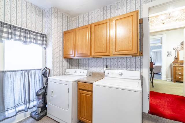 washroom with cabinets and washer and clothes dryer