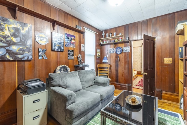 living room with wooden walls and wood-type flooring