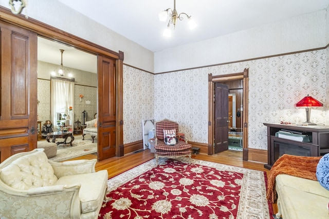 living room with a chandelier and light wood-type flooring