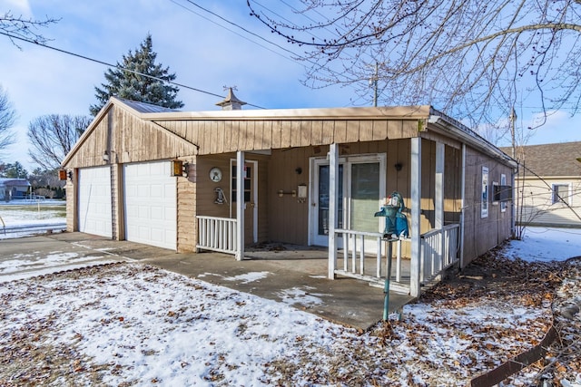 view of front of property featuring a garage and covered porch