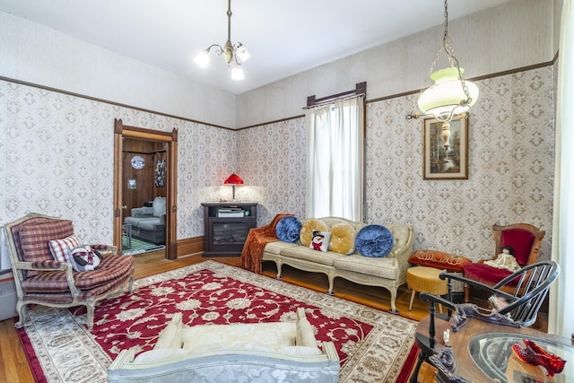 sitting room featuring a notable chandelier and hardwood / wood-style floors