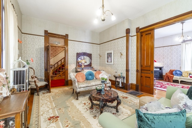 living area featuring a chandelier and light hardwood / wood-style flooring