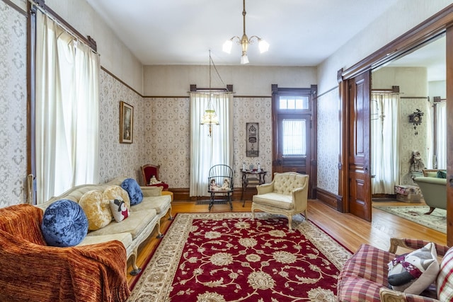 living room with a notable chandelier and light wood-type flooring